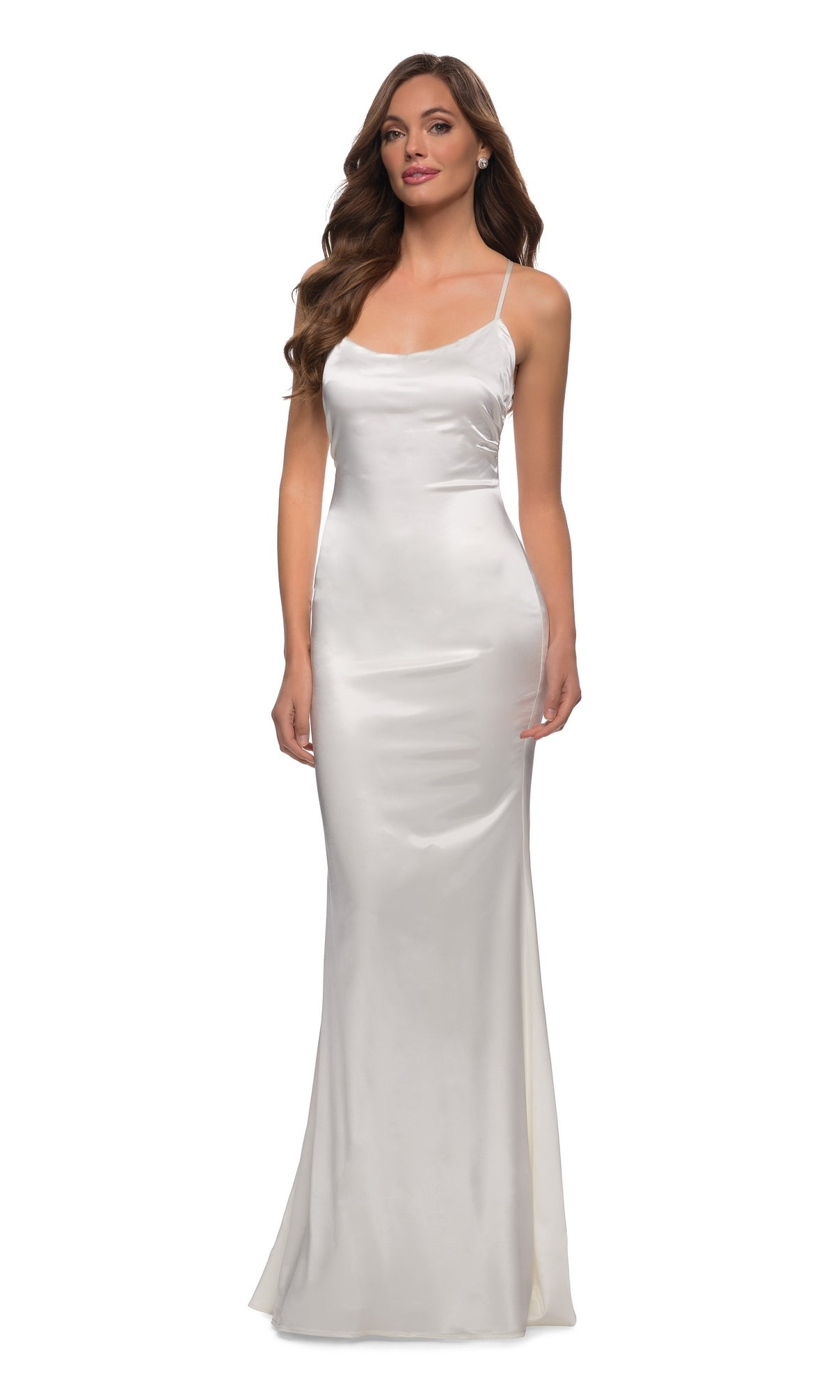 A woman wearing the La Femme 29858 Backless Simple Satin Prom Dress—a long, white gown with thin spaghetti straps—stands against a plain white background.